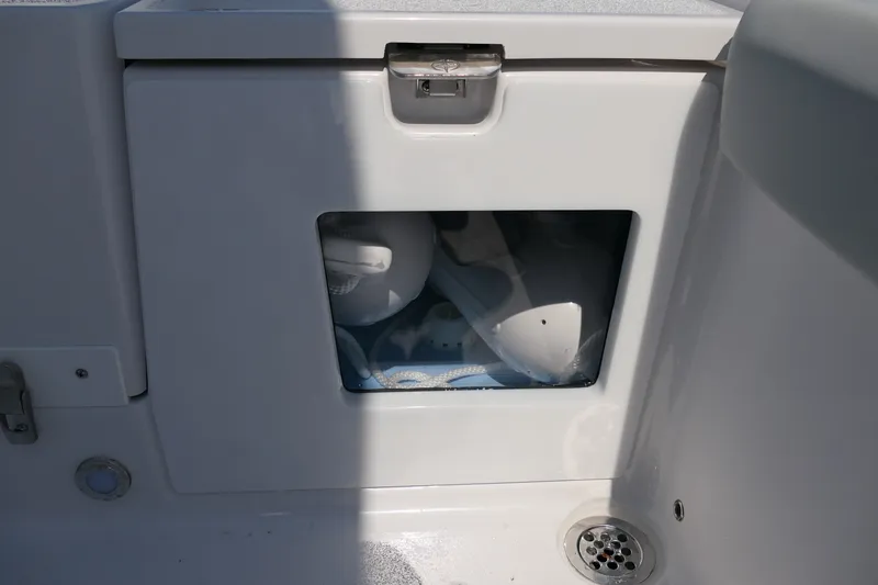 Slide: The Image of Storage compartment on a 2027 Blackfin 242 HB boat, featuring a transparent window. - 46