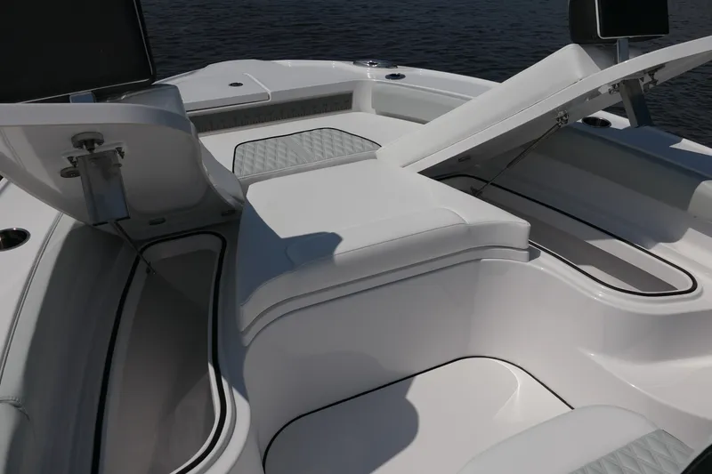 Slide: The Image of 2027 Blackfin 242 HB boat interior with open storage compartments and cushioned seating. - 23