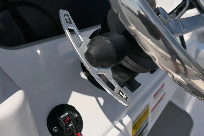 Slide: The Image of Steering wheel and controls of 2027 Blackfin 242 HB boat, showcasing modern design. - 31