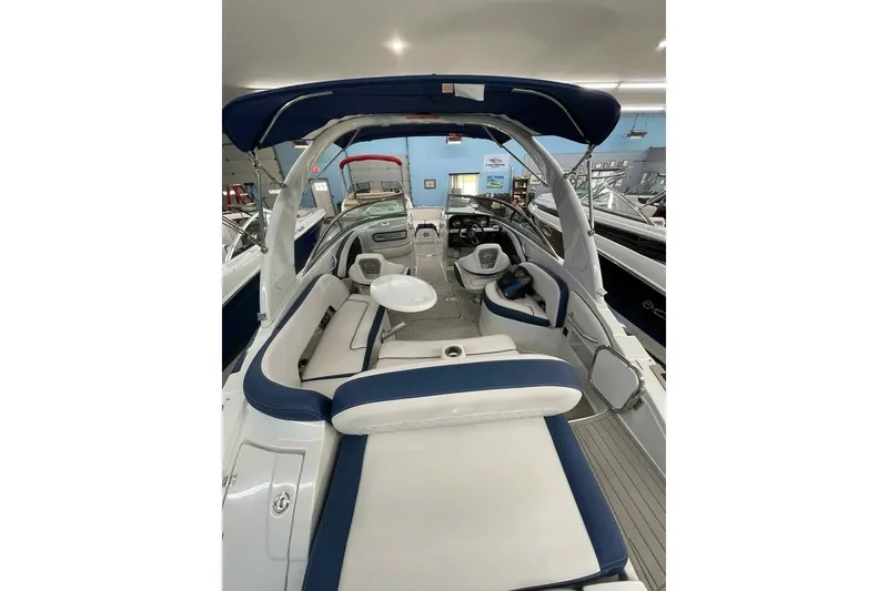 Slide: The Image of Interior view of 2021 Crownline 255 SS boat with blue and white seating. - 4