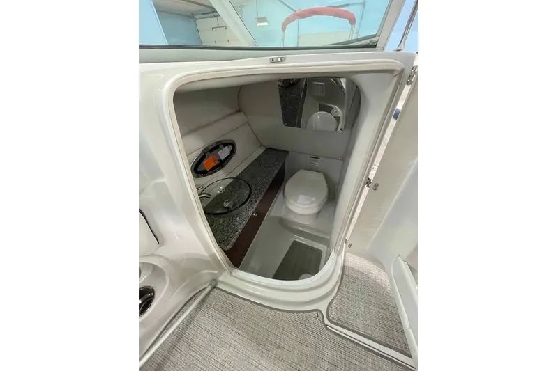 Slide: The Image of 2021 Crownline 255 SS boat interior bathroom with toilet and sink. - 6