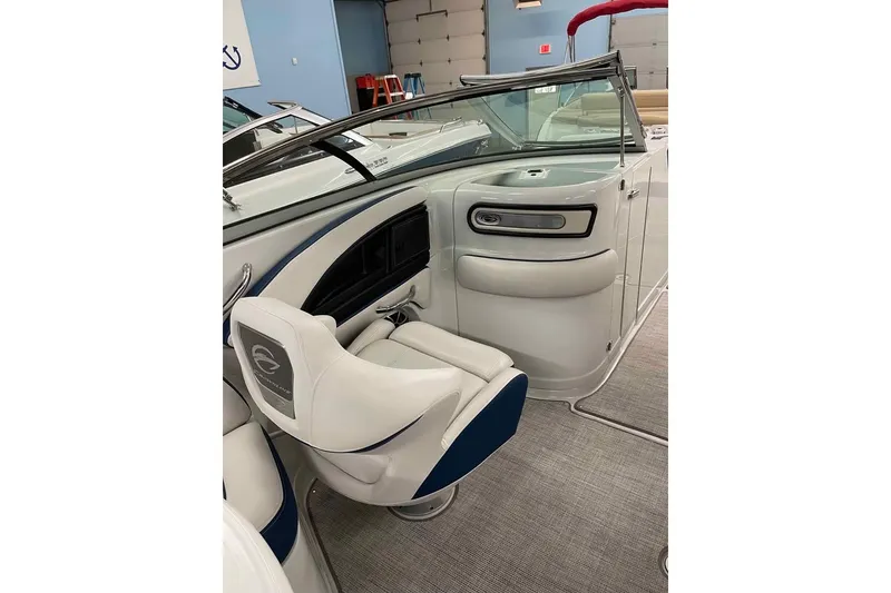 Slide: The Image of 2021 Crownline 255 SS boat interior with sleek seating and modern dashboard design. - 11