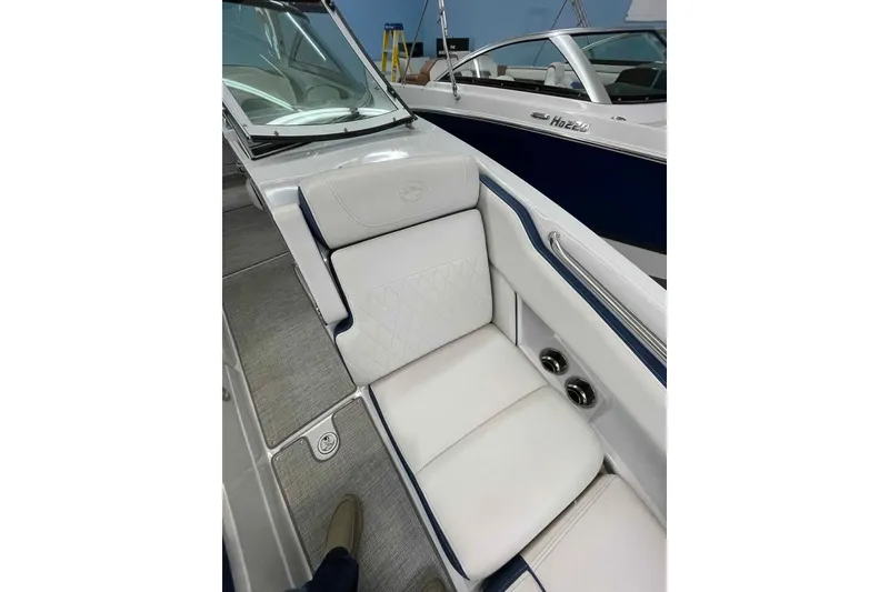 Slide: The Image of 2021 Crownline 255 SS boat interior with white seating and modern design. - 7