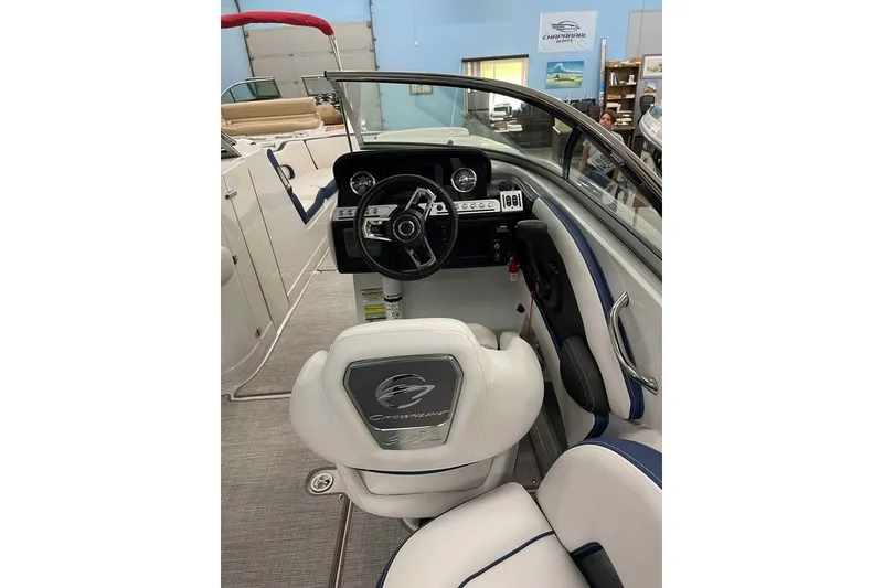 Slide: The Image of Interior view of 2021 Crownline 255 SS boat cockpit with steering wheel and seating. - 12