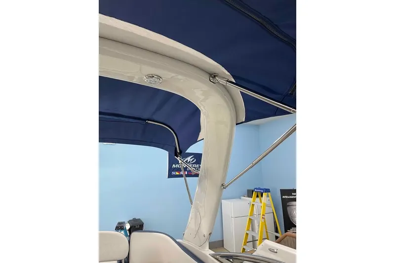 Slide: The Image of 2021 Crownline 255 SS boat interior with blue canopy and support structure. - 8