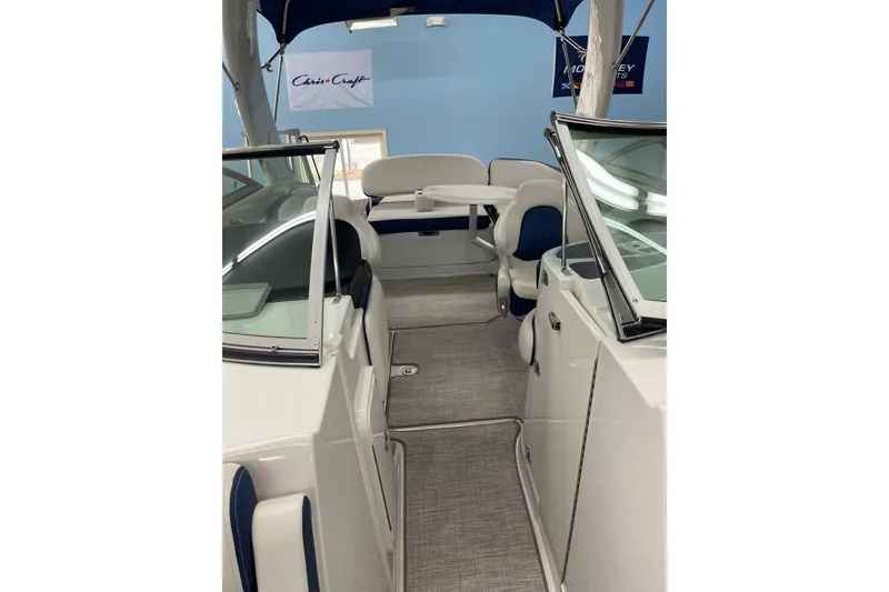 Slide: The Image of 2021 Crownline 255 SS boat interior with seating and canopy, showcasing modern design. - 9