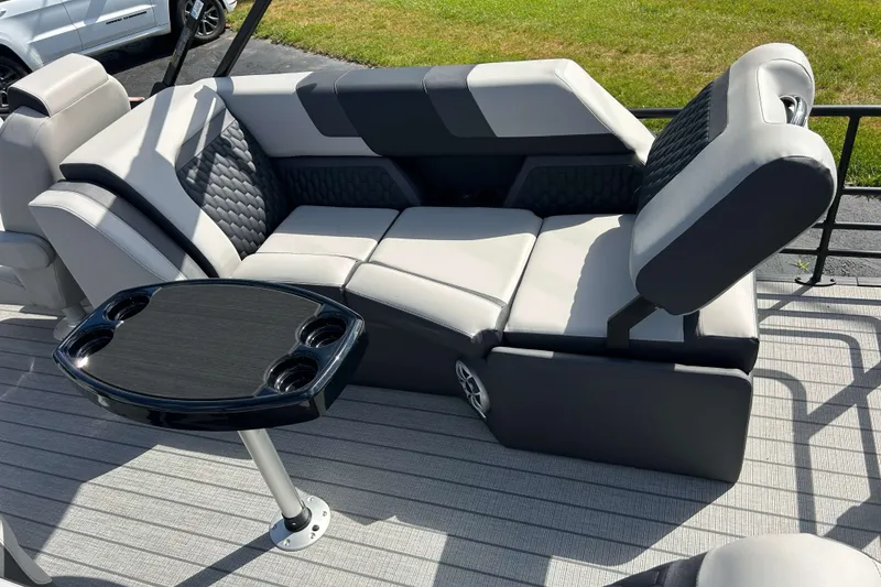 Slide: The Image of Luxurious seating on 2026 Sylvan L3 LZ Tritoon with cupholder table, outdoor setting. - 6