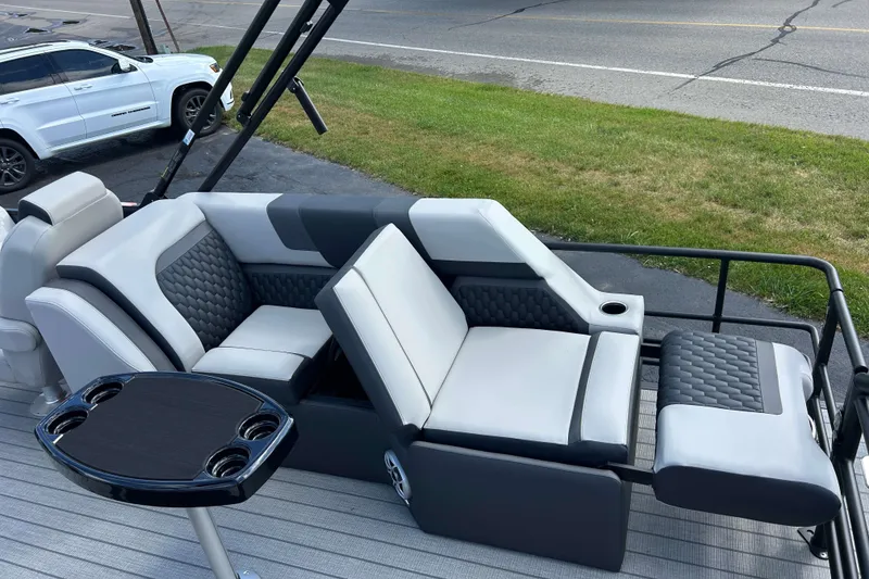 Slide: The Image of 2026 Sylvan L3 LZ Tritoon boat interior with luxurious seating and cup holders. - 8