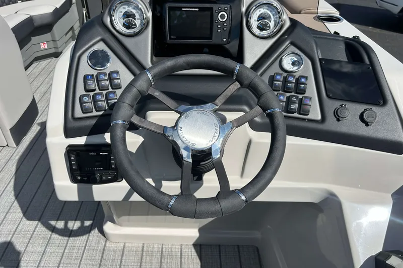 Slide: The Image of Steering console of 2026 Sylvan L3 LZ Tritoon with modern controls and gauges. - 13