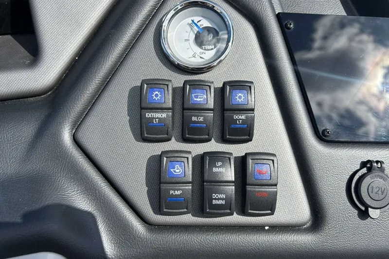 Slide: The Image of Control panel of 2026 Sylvan L3 LZ Tritoon with switches and trim gauge. - 18