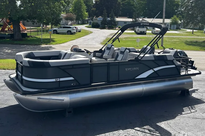 The Image of 2026 Sylvan L3 LZ Tritoon boat parked on a sunny street. - 0