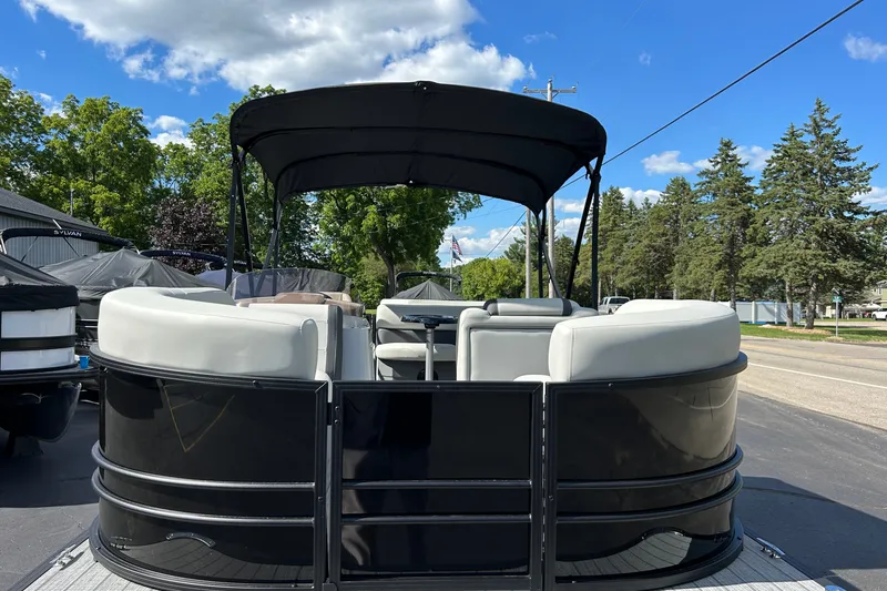 Slide: The Image of 2026 Sylvan Mirage 820 Cruise pontoon boat with canopy, parked outdoors under blue sky. - 15