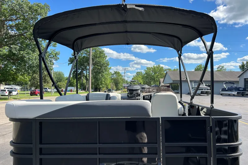 Slide: The Image of 2026 Sylvan Mirage 820 Cruise pontoon boat with canopy, parked outdoors. - 3