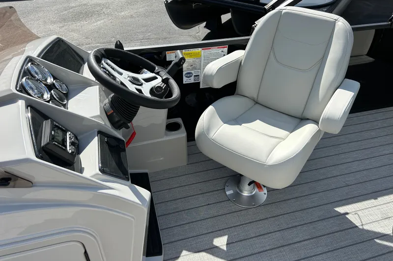Slide: The Image of Captain's chair and helm of 2026 Sylvan Mirage 820 Cruise boat, featuring modern controls. - 6