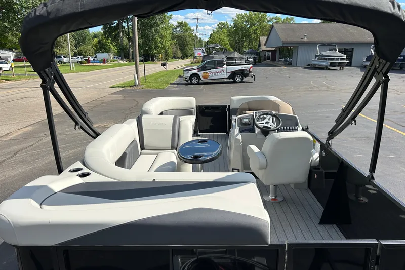 Slide: The Image of 2026 Sylvan Mirage 820 Cruise pontoon boat interior with seating and steering console. - 2