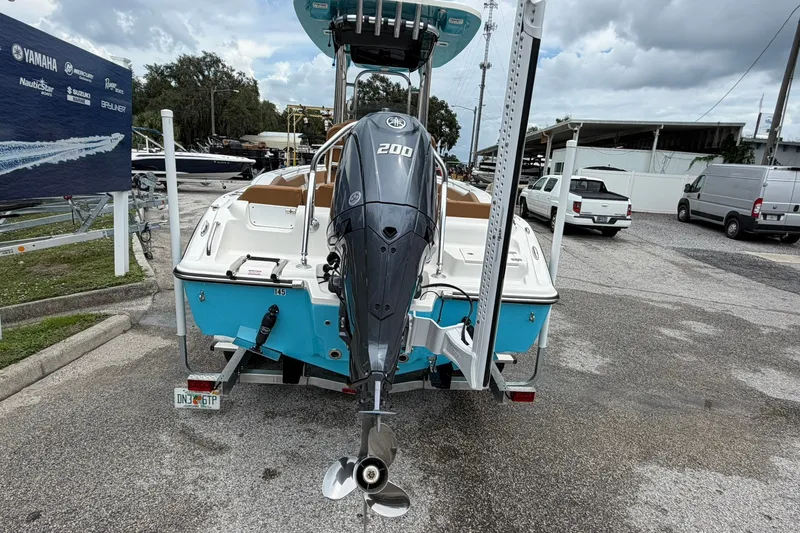 Slide: The Image of 2025 Key West 219 FS boat with Yamaha 200 engine, parked outdoors. - 32