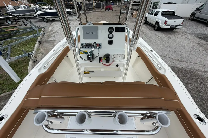 Slide: The Image of 2025 Key West 219 FS boat interior with Garmin navigation system and brown seating. - 9