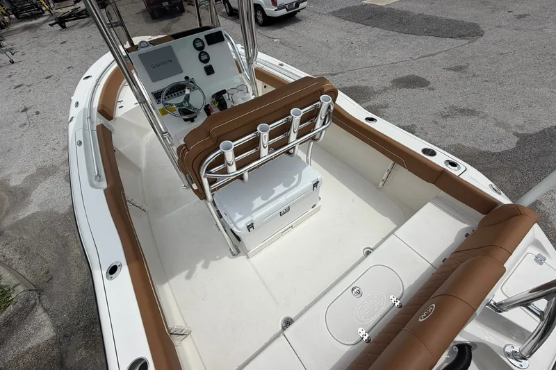 Slide: The Image of 2025 Key West 219 FS boat interior with brown seating and modern console. - 13