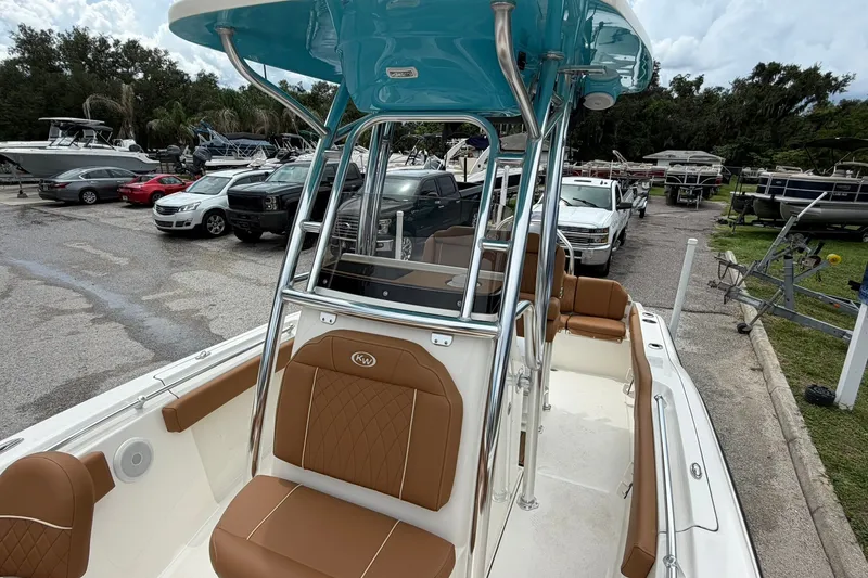 Slide: The Image of 2025 Key West 219 FS boat with brown seating, parked in a marina. - 17