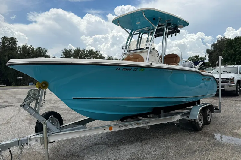 Slide: The Image of 2025 Key West 219 FS boat on trailer, parked outdoors under cloudy sky. - 30