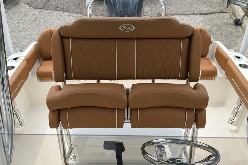 Slide: The Image of 2025 Key West 219 FS boat interior with tan leather seating and steering wheel. - 21