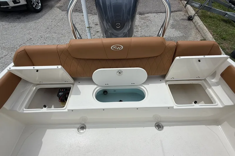 Slide: The Image of 2025 Key West 219 FS boat interior with storage compartments and cushioned seating. - 15