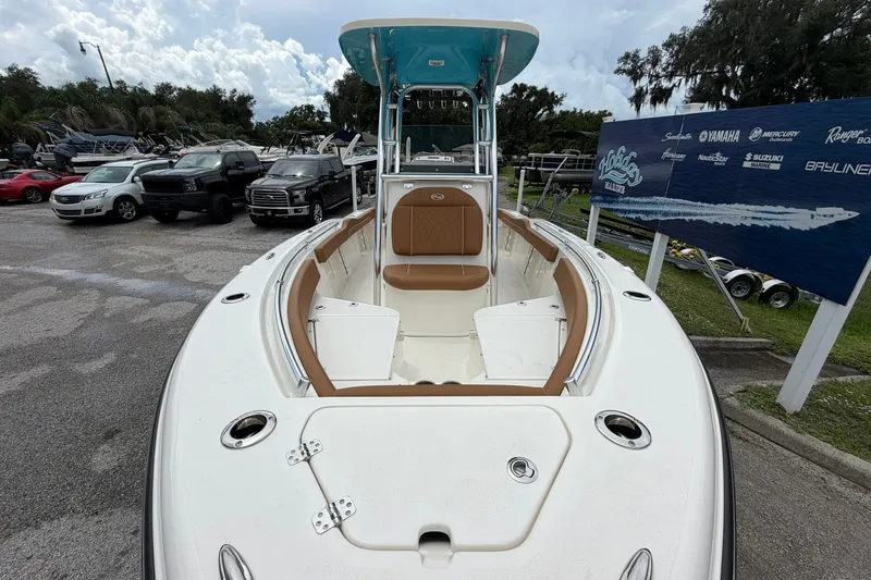Slide: The Image of 2025 Key West 219 FS boat displayed outdoors with seating and console. - 1