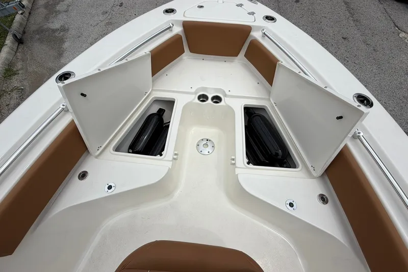 Slide: The Image of 2025 Key West 219 FS boat deck with open storage compartments. - 10