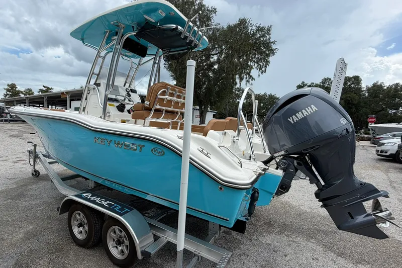 Slide: The Image of 2025 Key West 219 FS boat with Yamaha engine on trailer, parked outdoors. - 31