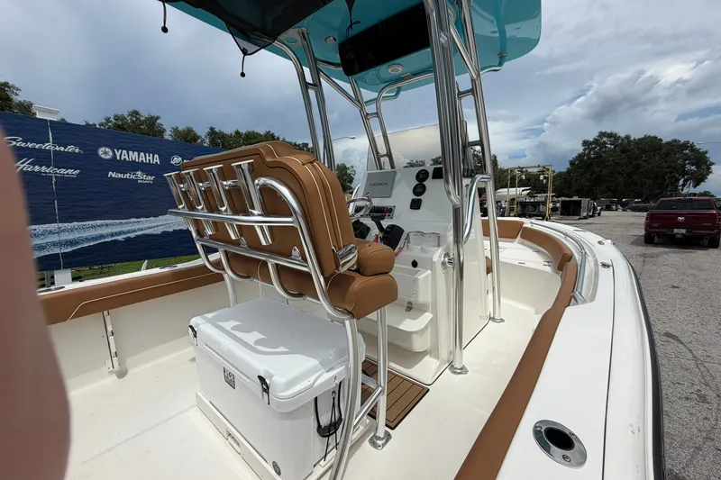 Slide: The Image of 2025 Key West 219 FS boat interior with tan seating and modern controls. - 3
