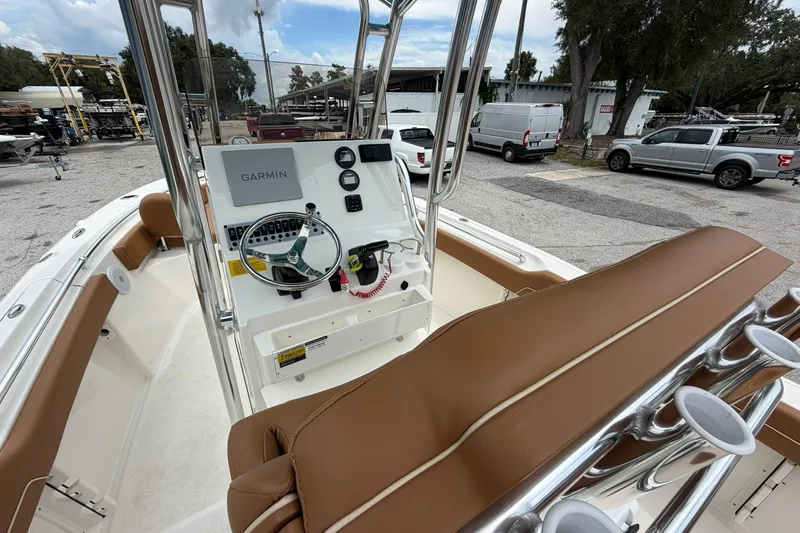 Slide: The Image of 2025 Key West 219 FS boat interior with Garmin navigation system and brown seating. - 24
