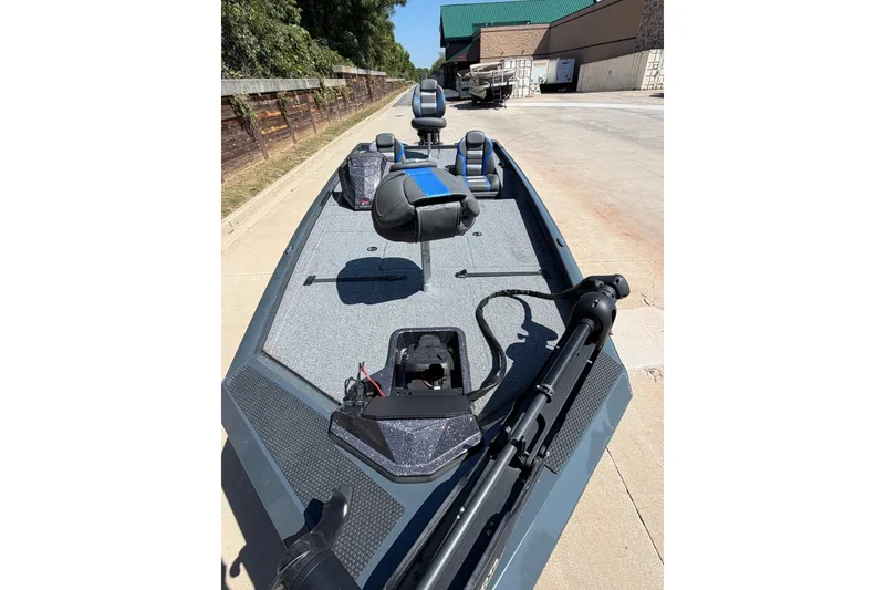 Slide: The Image of 2023 Ranger RT198P fishing boat on a sunny day, parked on a concrete surface. - 4