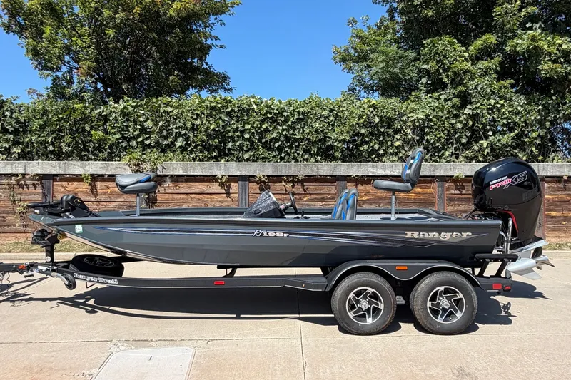 The Image of 2023 Ranger RT198P fishing boat on trailer, parked outdoors. - 1