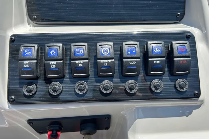 Slide: The Image of Control panel of 2026 Sylvan Mirage 820 LZ boat with labeled switches. - 10