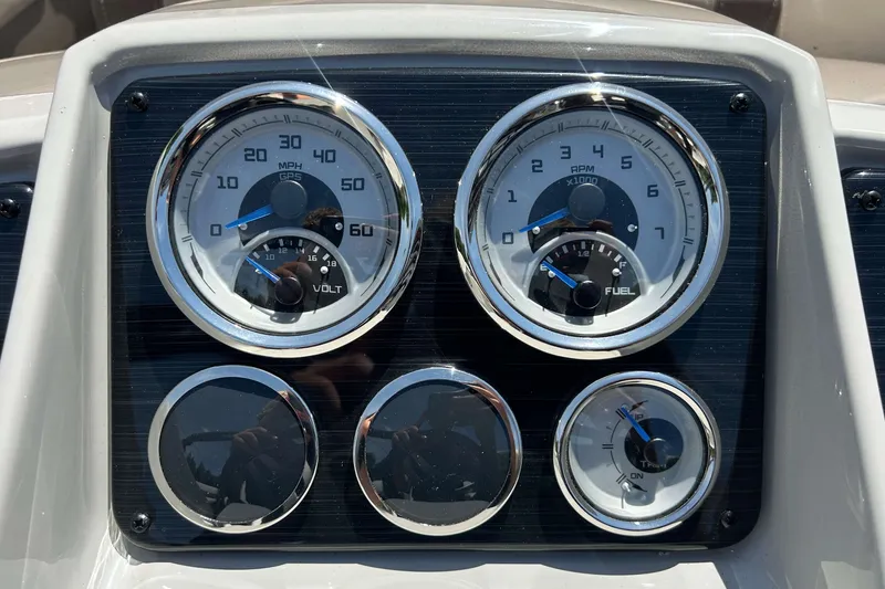 Slide: The Image of Dashboard gauges of 2026 Sylvan Mirage 820 LZ boat, displaying speed, RPM, voltage, and fuel levels. - 11