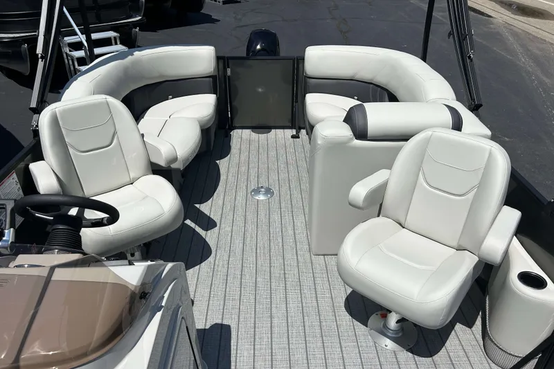 Slide: The Image of 2026 Sylvan Mirage 820 LZ pontoon boat interior with white seating and steering console. - 7