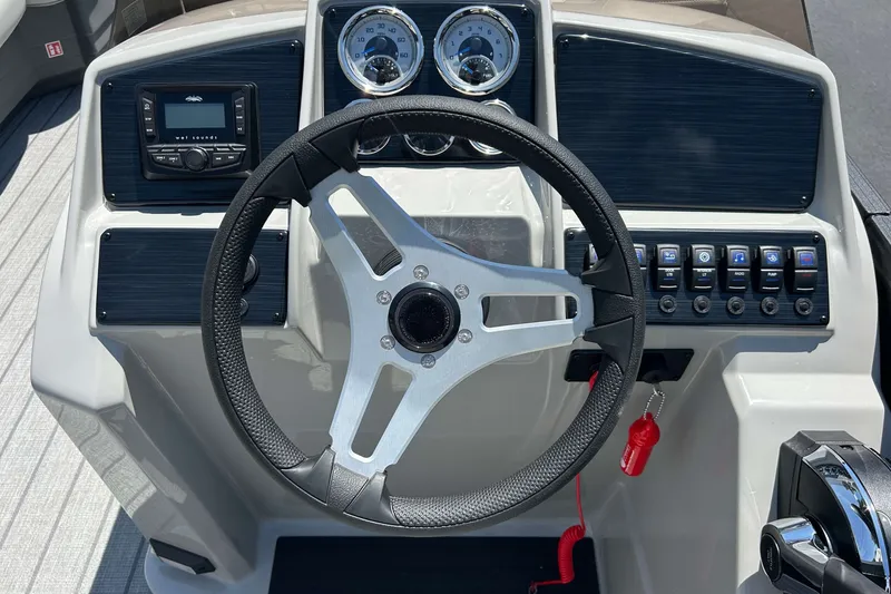 Slide: The Image of Steering console of 2026 Sylvan Mirage 820 LZ boat with gauges and controls. - 8