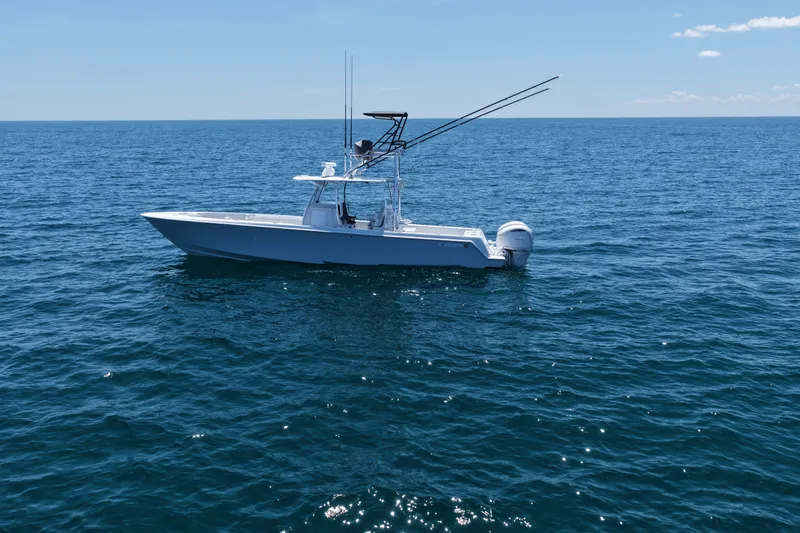 Slide: The Image of 2025 Contender 39 ST boat on open ocean under clear blue sky. - 3