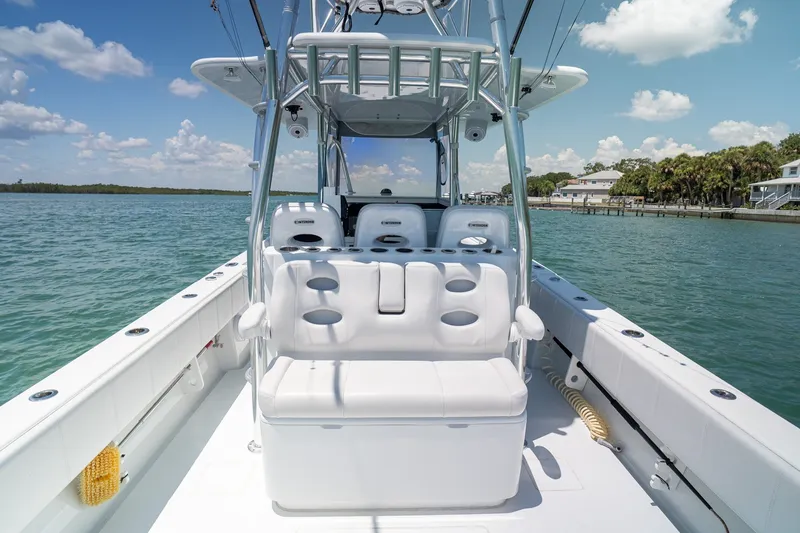 Slide: The Image of 2025 Contender 39 ST boat interior with seating, on a sunny day by the water. - 11