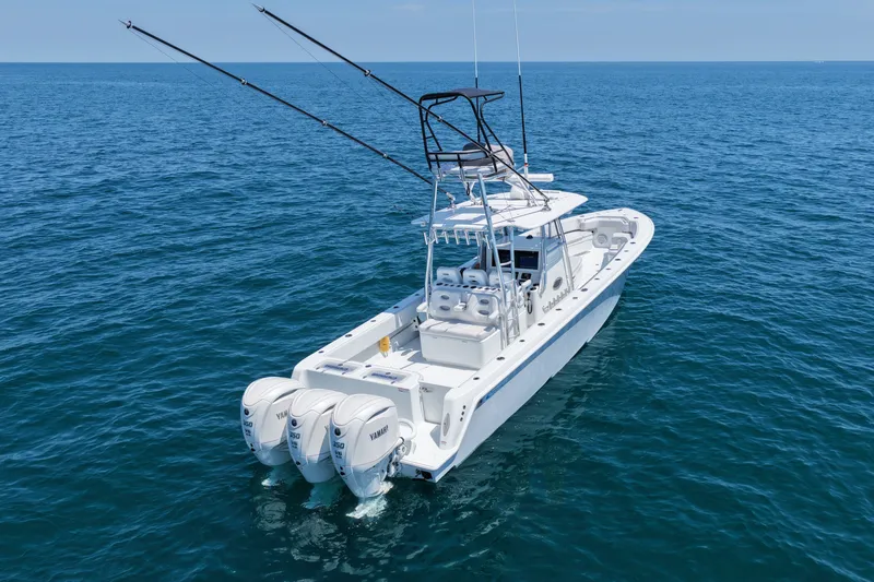Slide: The Image of 2025 Contender 39 ST boat with triple Yamaha engines on open sea. - 6