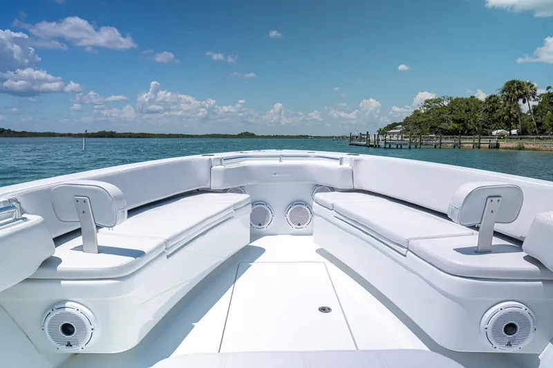 Slide: The Image of 2025 Contender 39 ST boat interior with white seating on a sunny day. - 8