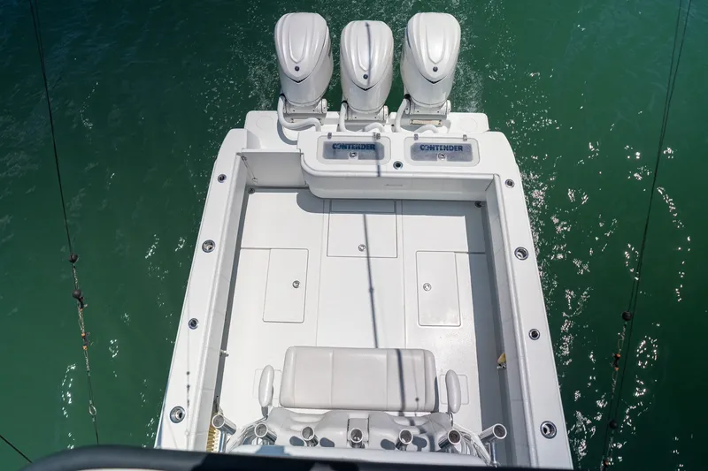 Slide: The Image of 2025 Contender 39 ST boat with triple engines on turquoise water. - 22