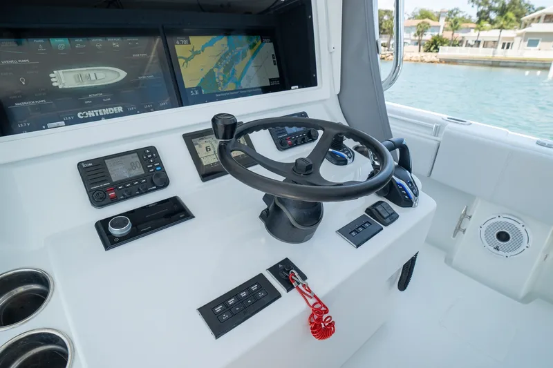 Slide: The Image of Helm of 2025 Contender 39 ST boat with advanced navigation displays and controls. - 17