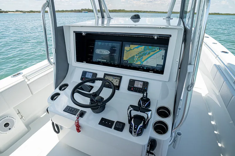 Slide: The Image of 2025 Contender 39 ST boat console with advanced navigation system and controls. - 14