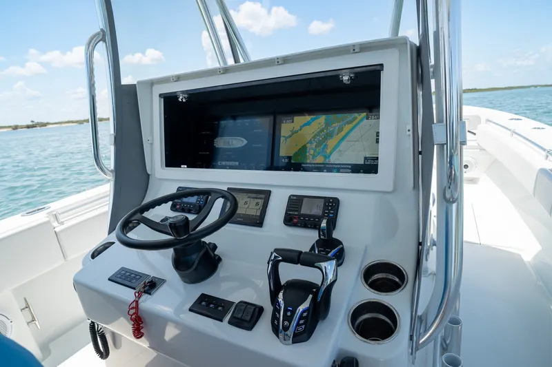 Slide: The Image of 2025 Contender 39 ST boat dashboard with navigation screens and controls. - 13