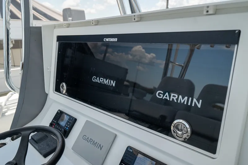 Slide: The Image of Dashboard of 2025 Contender 39 ST boat featuring Garmin navigation systems. - 27