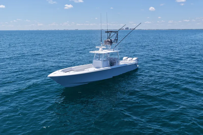 Slide: The Image of 2025 Contender 39 ST boat on open ocean under clear sky. - 4