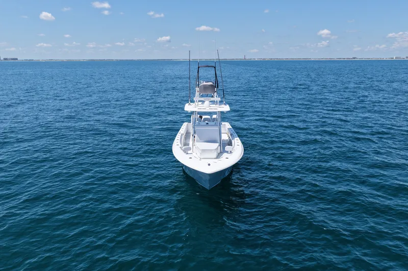 Slide: The Image of 2025 Contender 39 ST boat on open ocean under clear blue sky. - 7