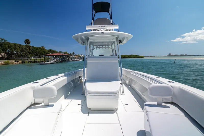 Slide: The Image of 2025 Contender 39 ST boat on calm waters, showcasing sleek design and spacious deck. - 9