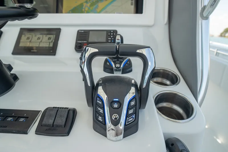 Slide: The Image of Control panel of 2025 Contender 39 ST boat with advanced navigation and throttle systems. - 15